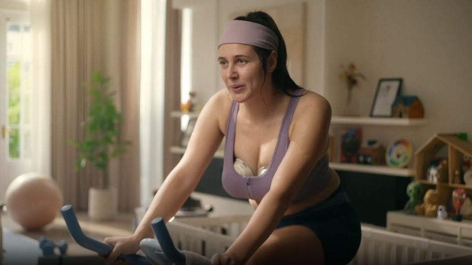 Mother using a wearable breast pump at home